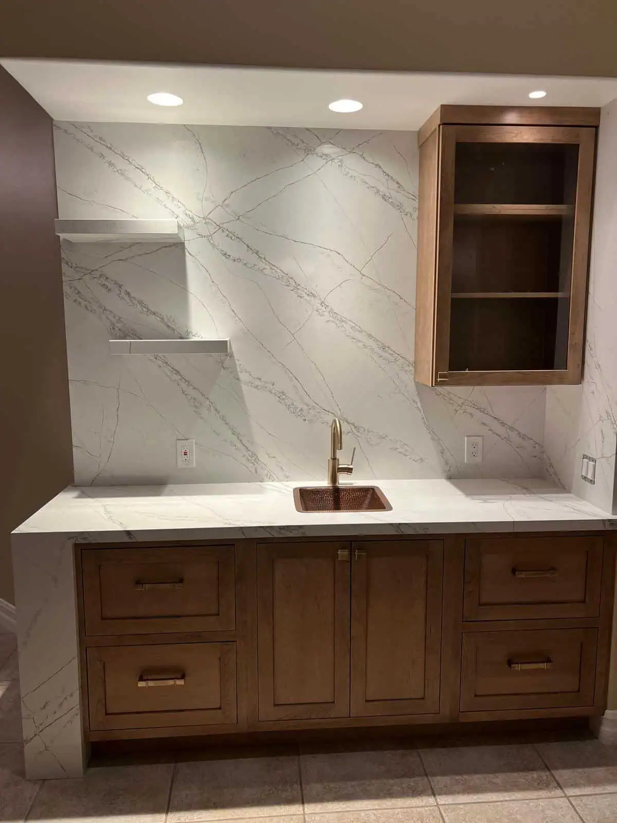 Elegant kitchen with marble backsplash and wooden cabinetry for a modern look.