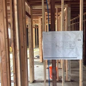Electrical wiring and electrical panel installation inside a building under construction.
